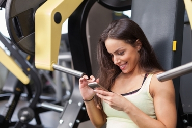 Even in the gym, social media fitness personalities update their feeds
